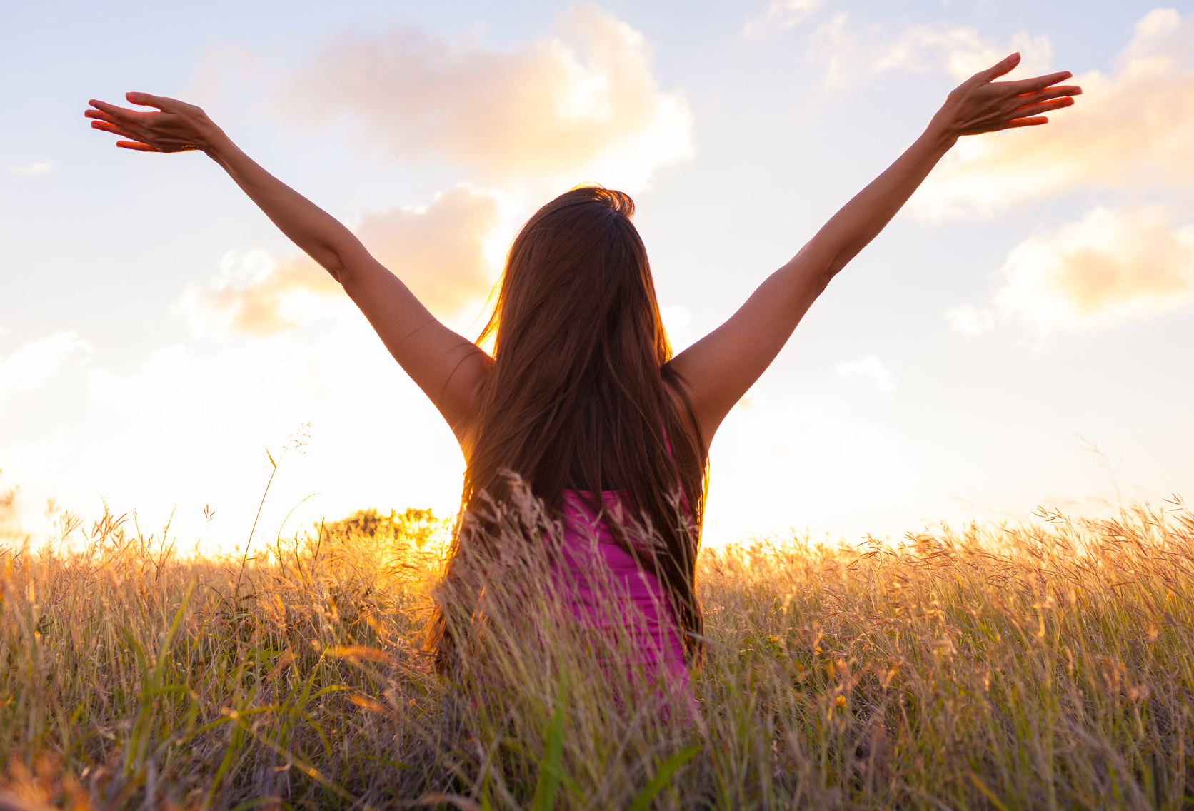 Woman feeling free in a beautiful natural setting.